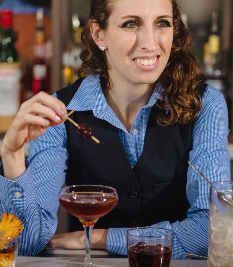 bartender sitting at a table with a drink
