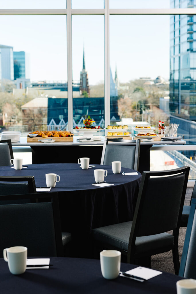 conference tables in a room with a buffet table at the back